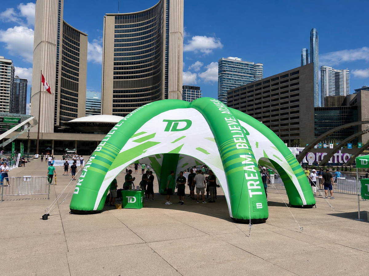 Green branded inflatable event tent installed for an outdoor promotional activation