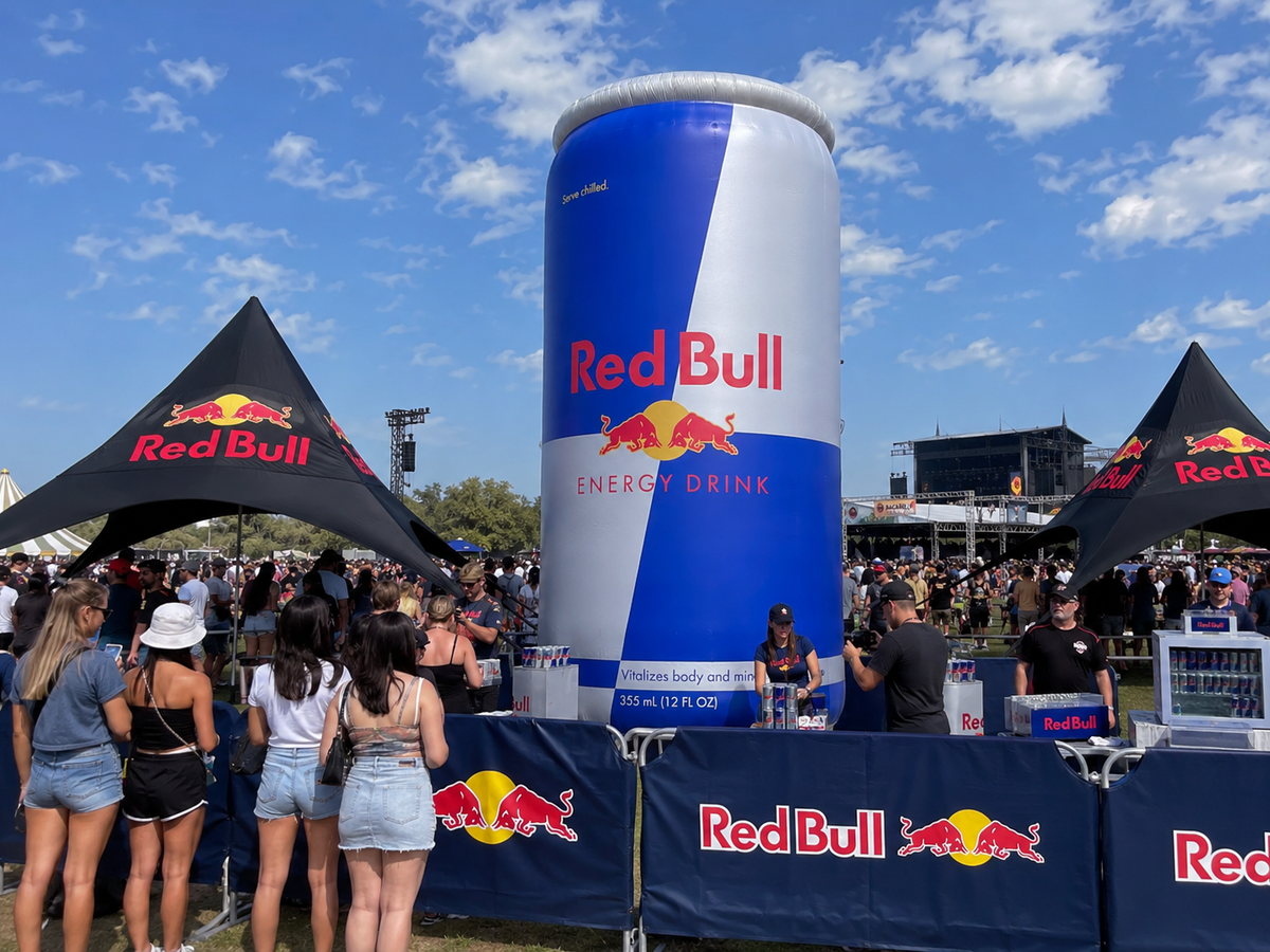 Giant inflatable beverage can replica displayed at an outdoor brand activation and festival